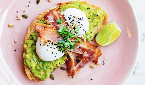 A poached egg, bacon and avocado on toast